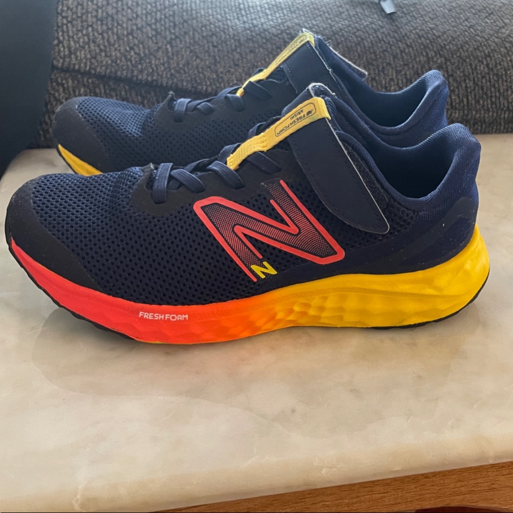 New Balance Kids Navy Sneakers with Red and Yellow Accents (wide fit)